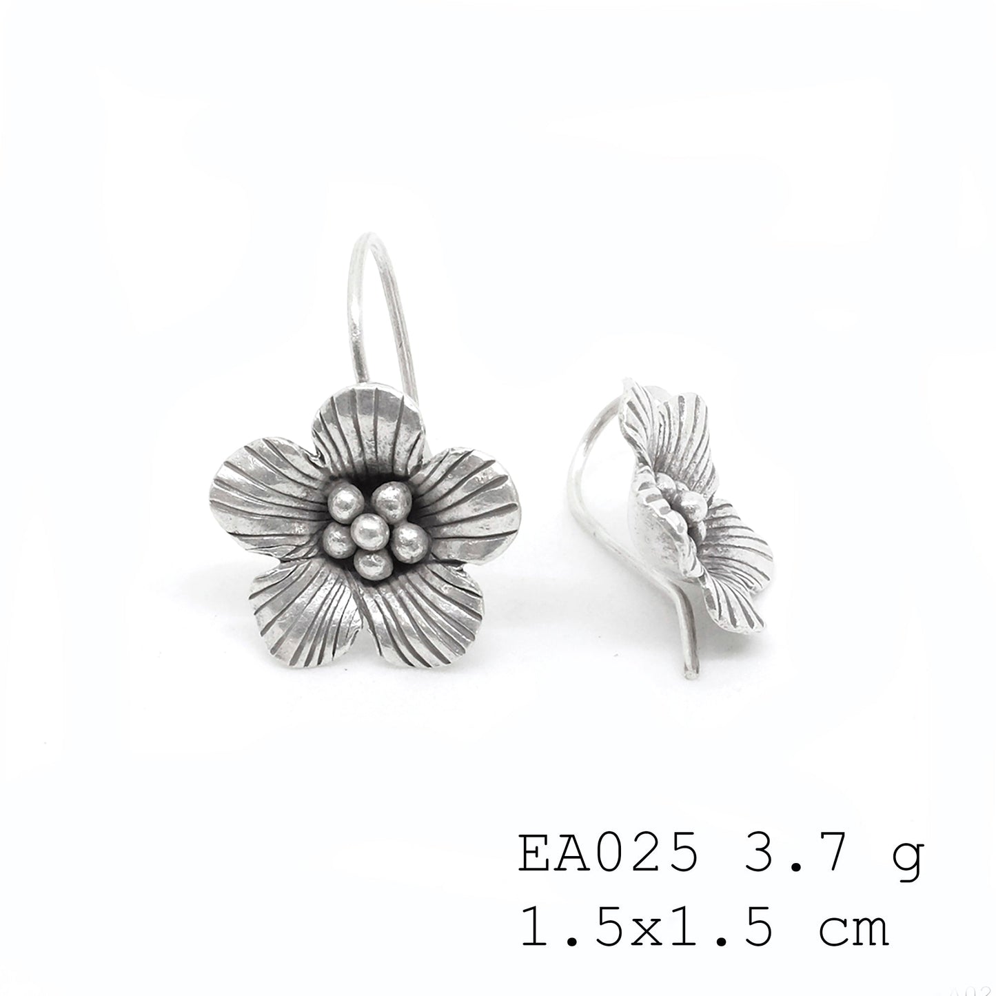 The finishing touch: delicate silver earrings.