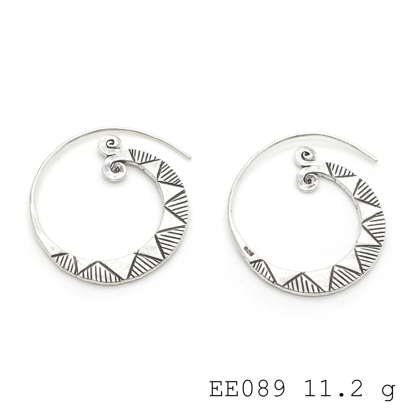 Swirls of sophistication. Dressed up with these silver earrings.
