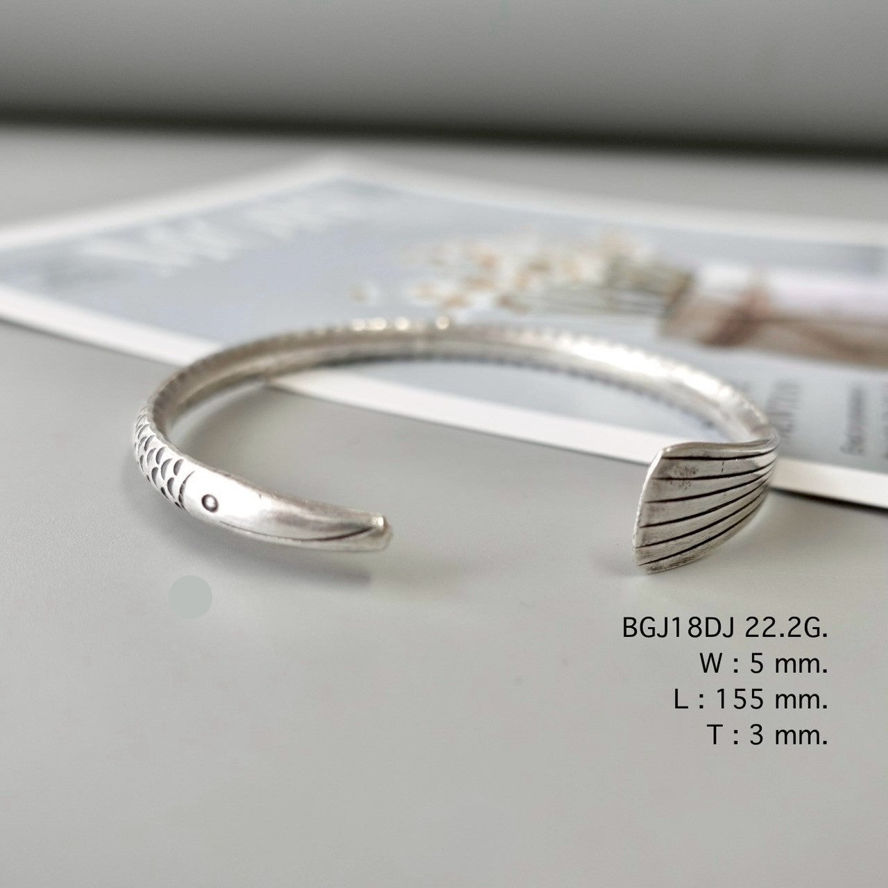 Silver bangle, artisan-crafted perfection.