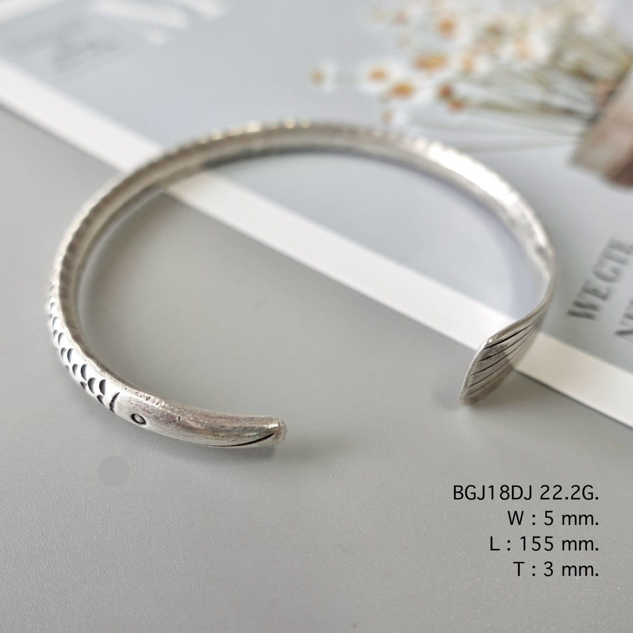 Silver bangle, artisan-crafted perfection.