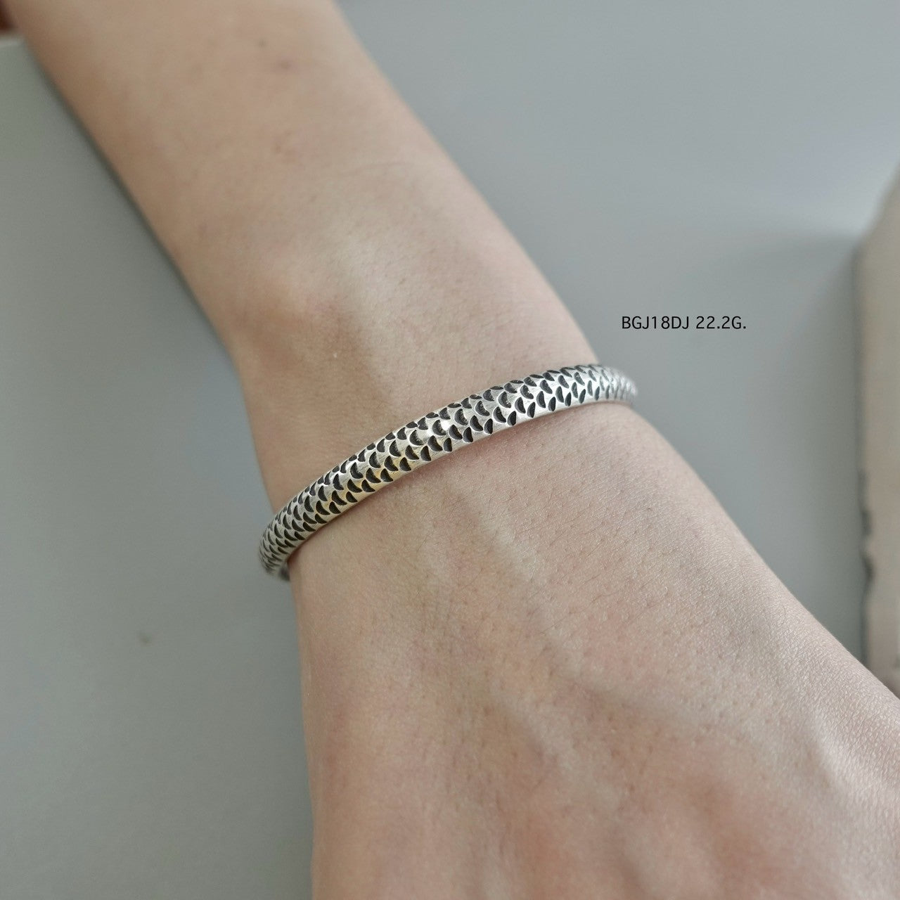 Silver bangle, artisan-crafted perfection.
