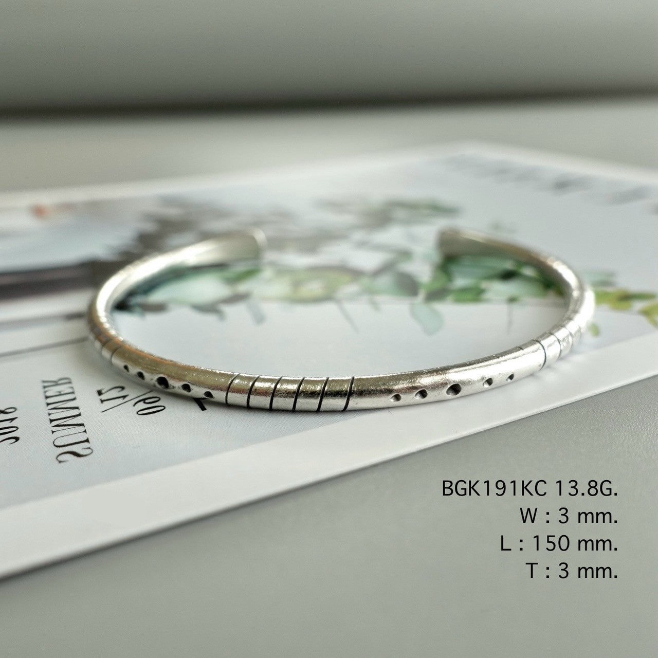 Simplicity shines in a silver bangle.