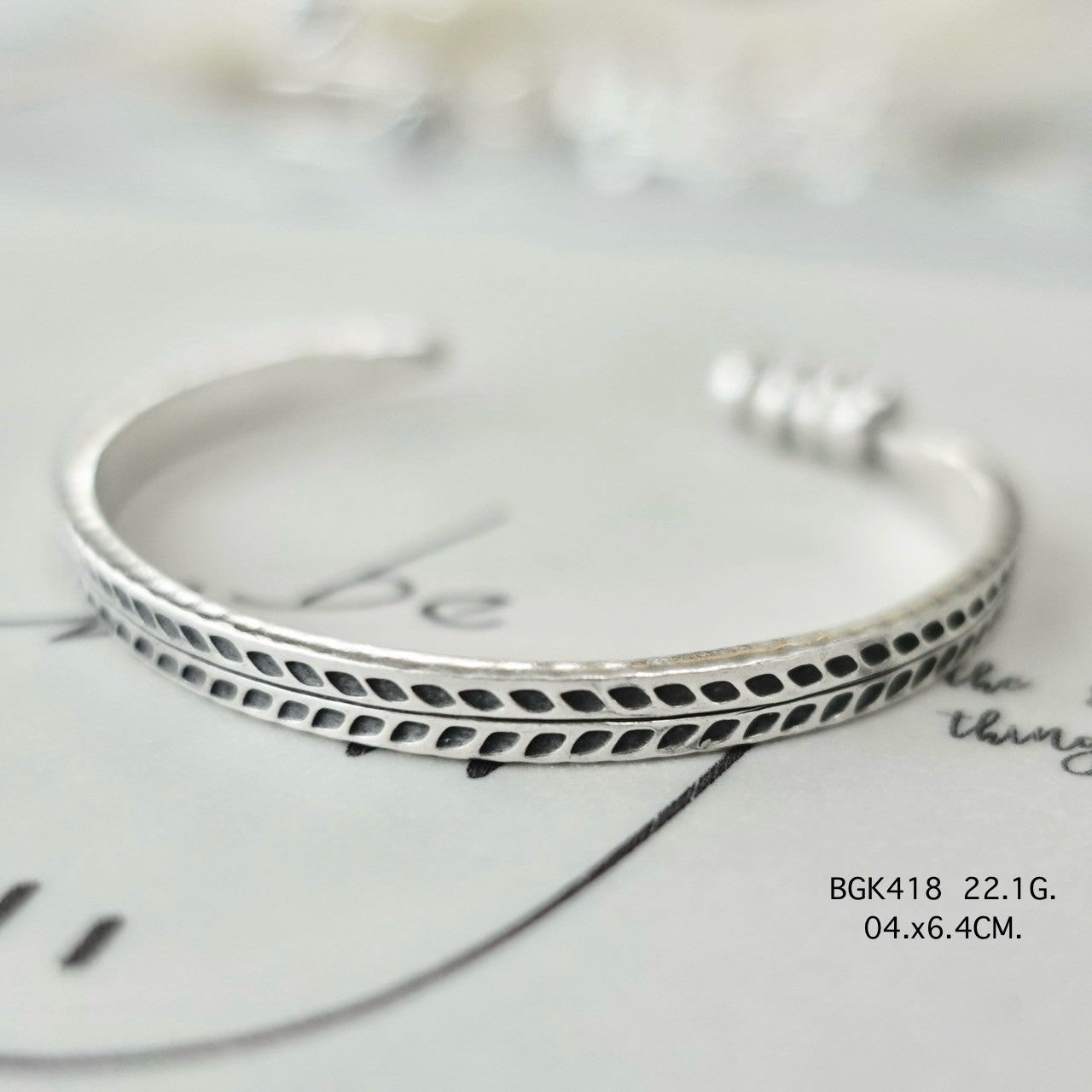 Silver bangle. Luxury, rooted in tradition.