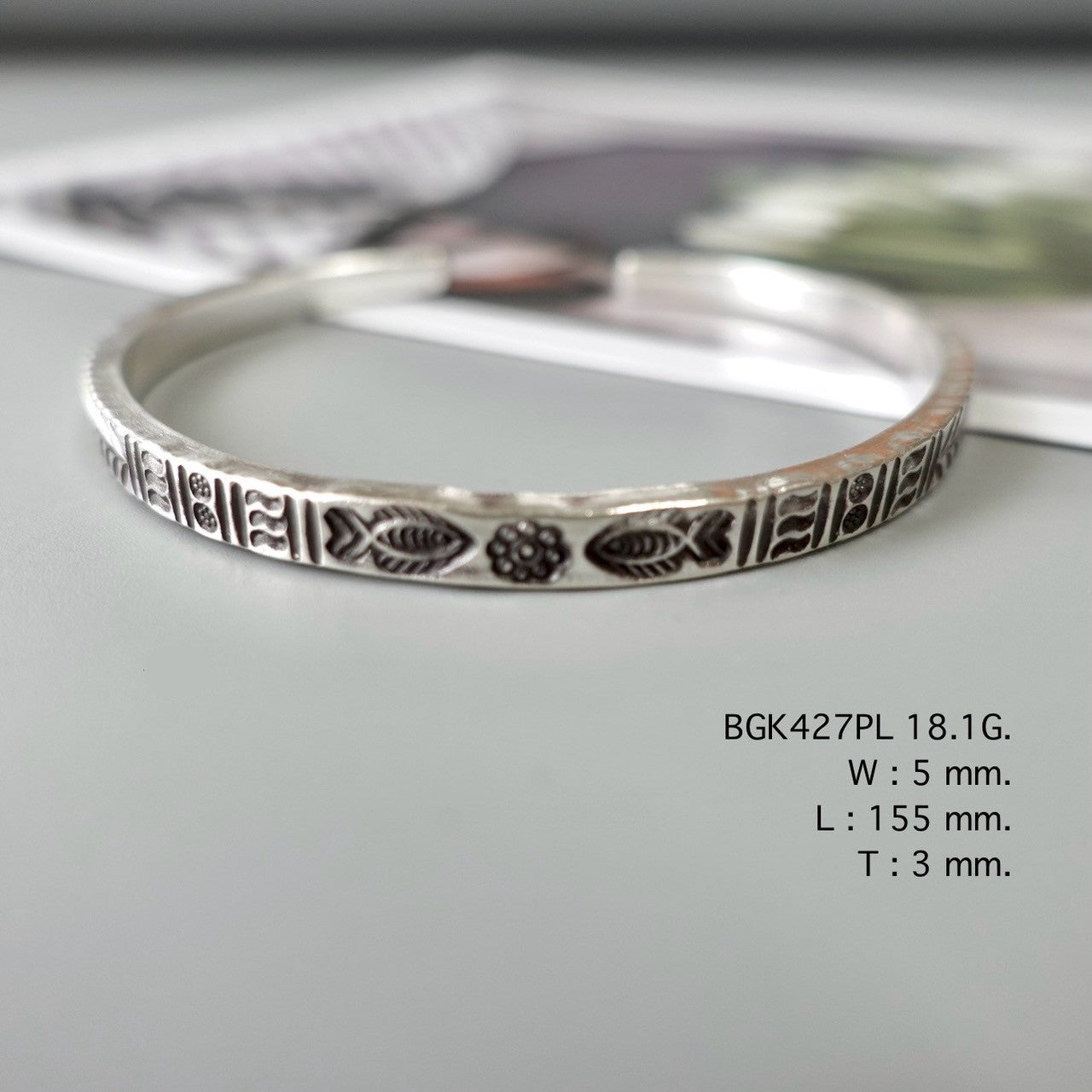 This bangle is silver poetry.