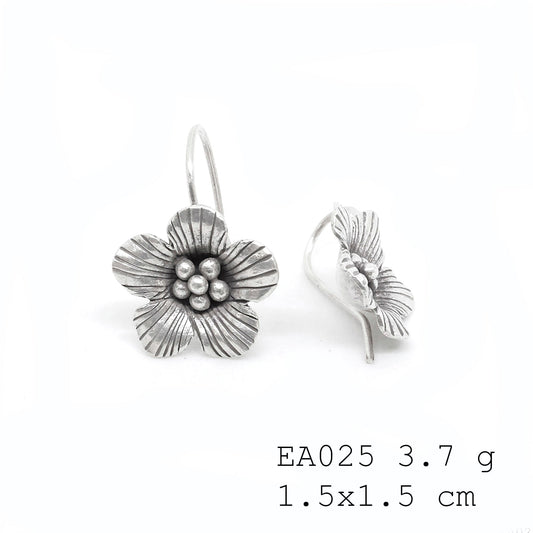 The finishing touch: delicate silver earrings.