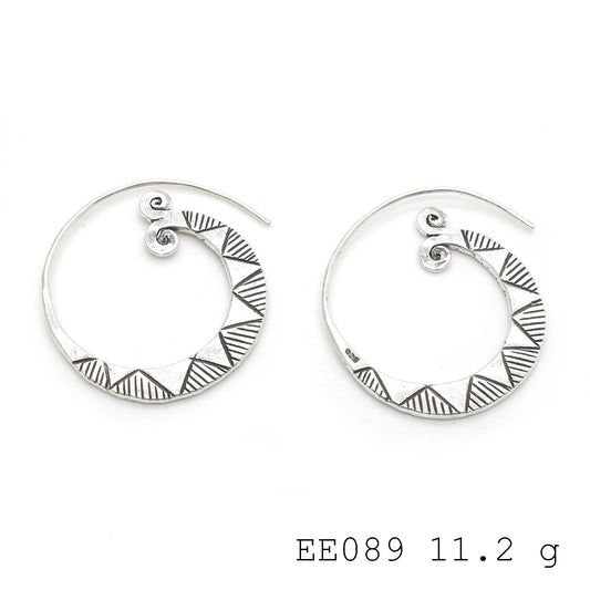 Swirls of sophistication. Dressed up with these silver earrings.