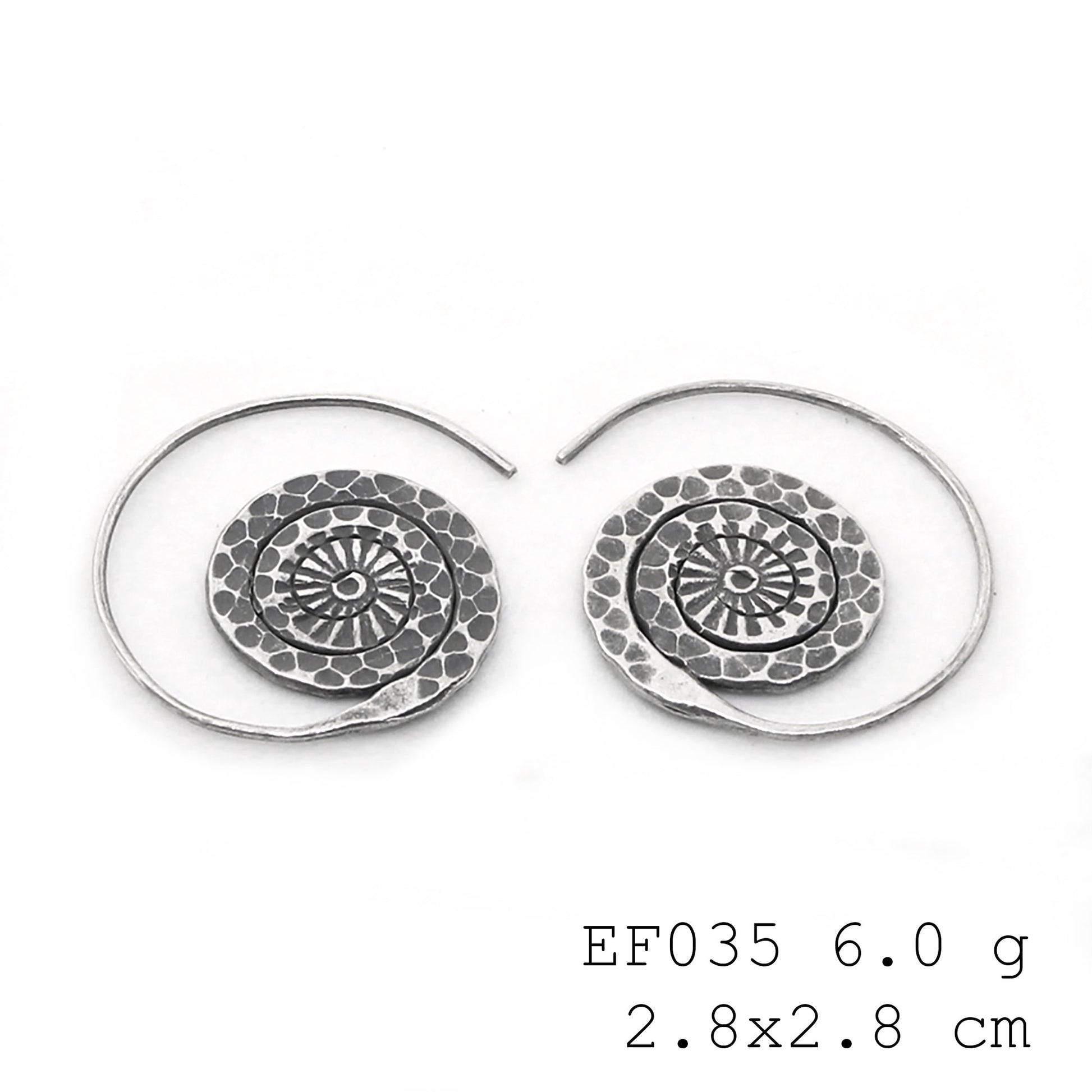 Adding a dynamic spin to my style with these silver earrings.