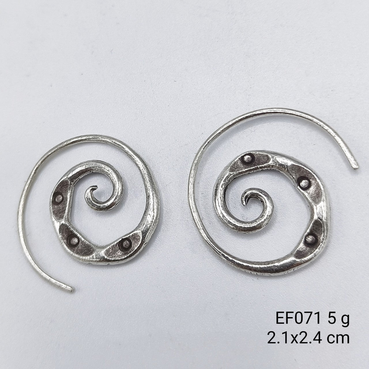 Elegant rotation. A timeless pair of spiral silver earrings.