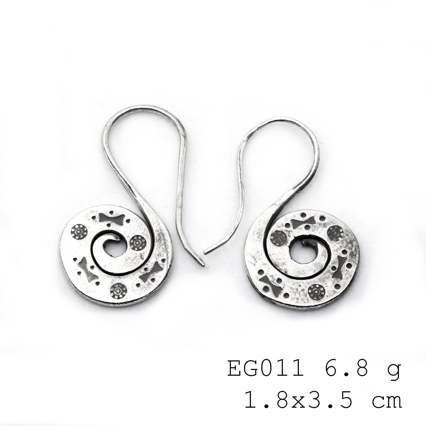 Unique textures on handmade silver earrings.