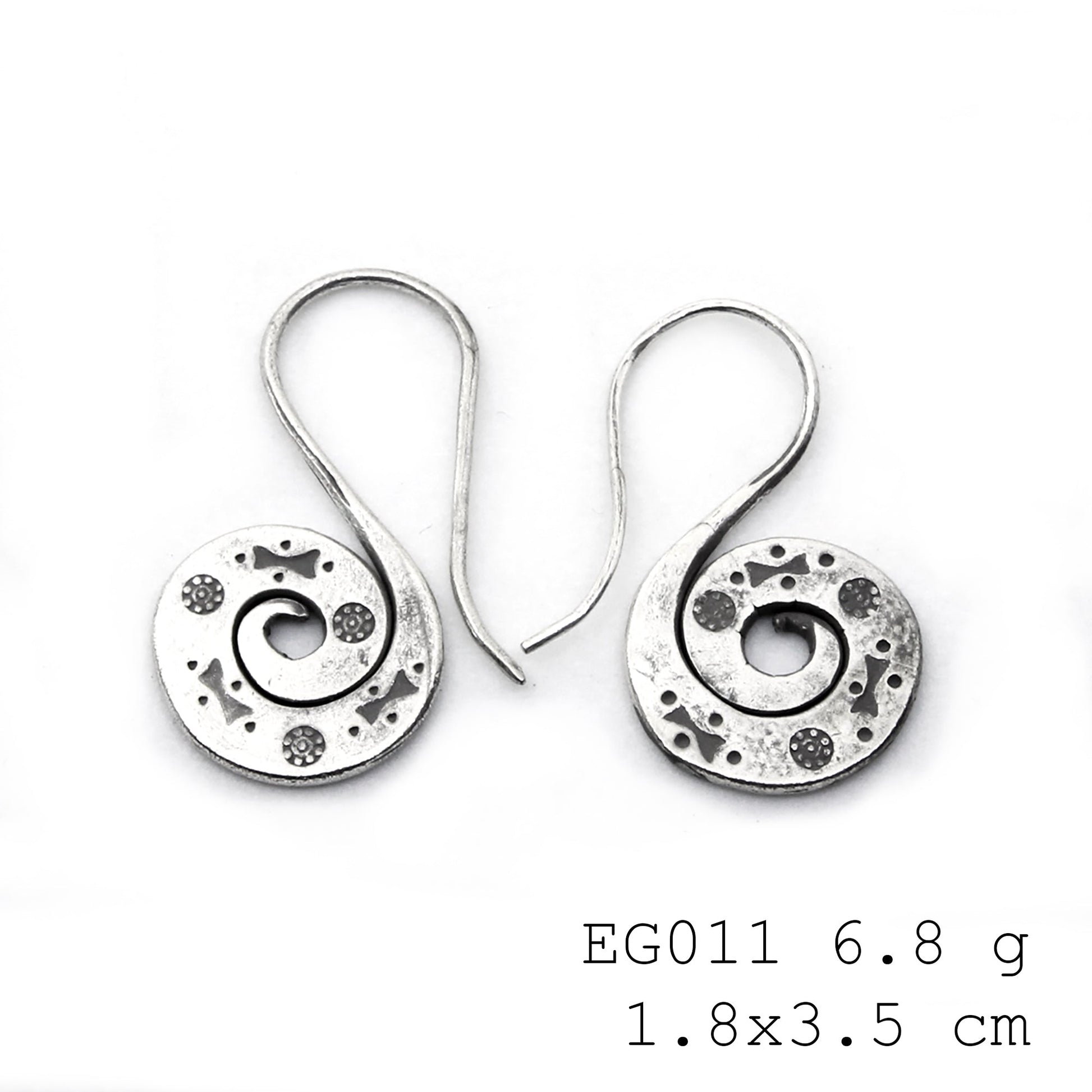 Unique textures on handmade silver earrings.