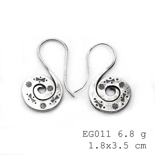 Unique textures on handmade silver earrings.