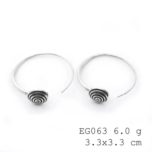 Subtle shine, bold silver earrings.