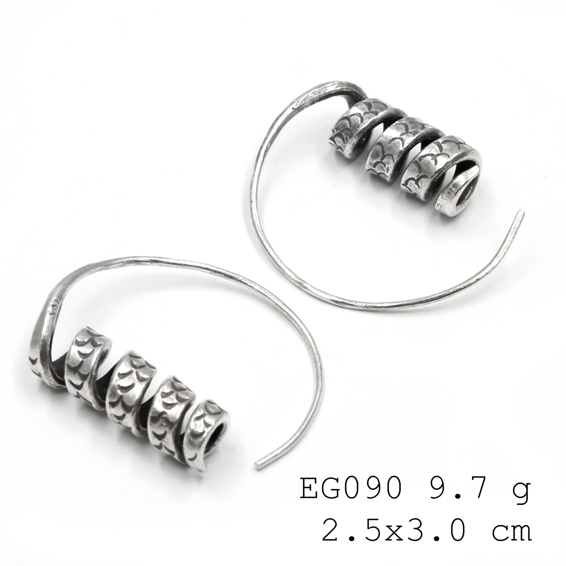 Wearable art in the form of silver earrings.