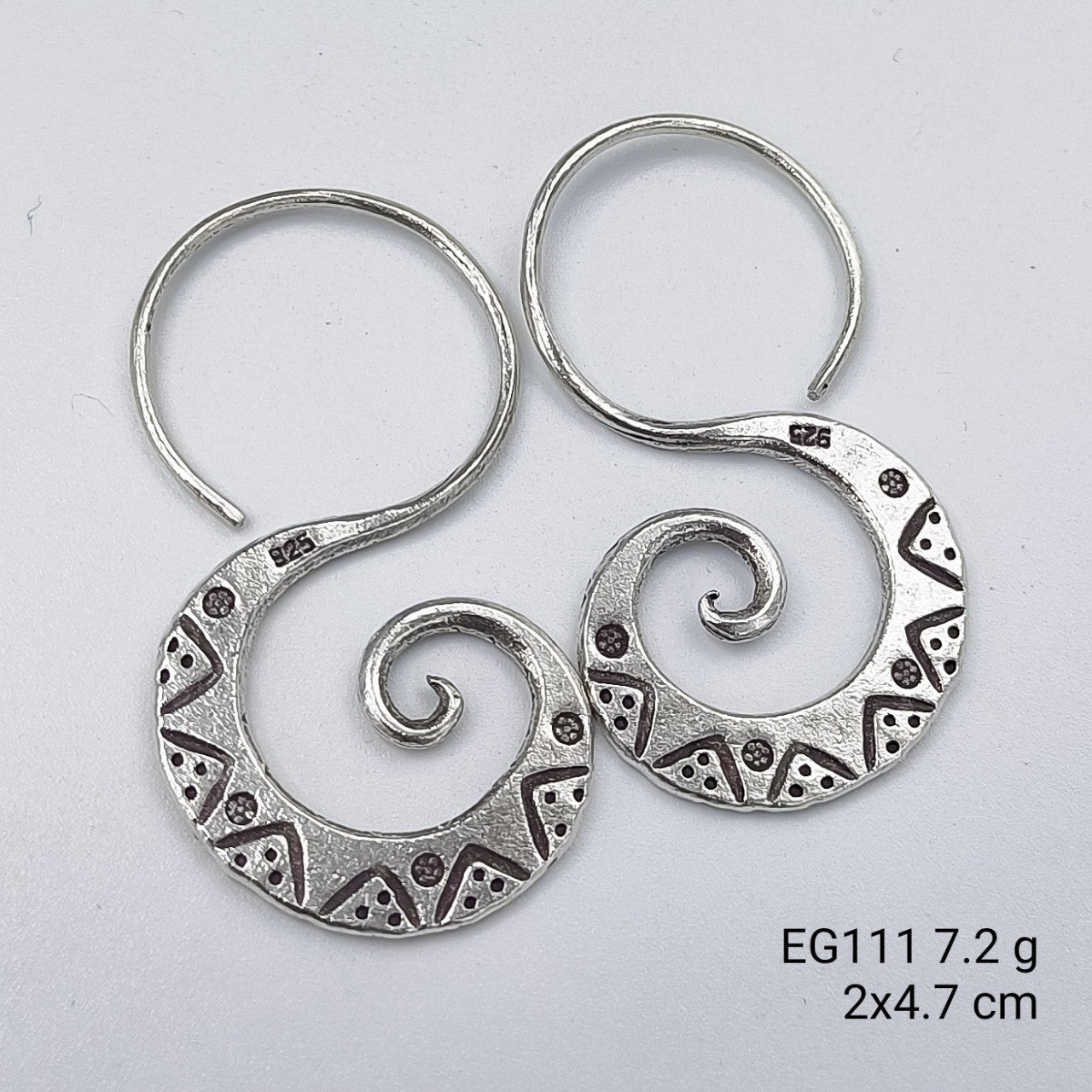 Sleek silhouettes in pure silver earrings.