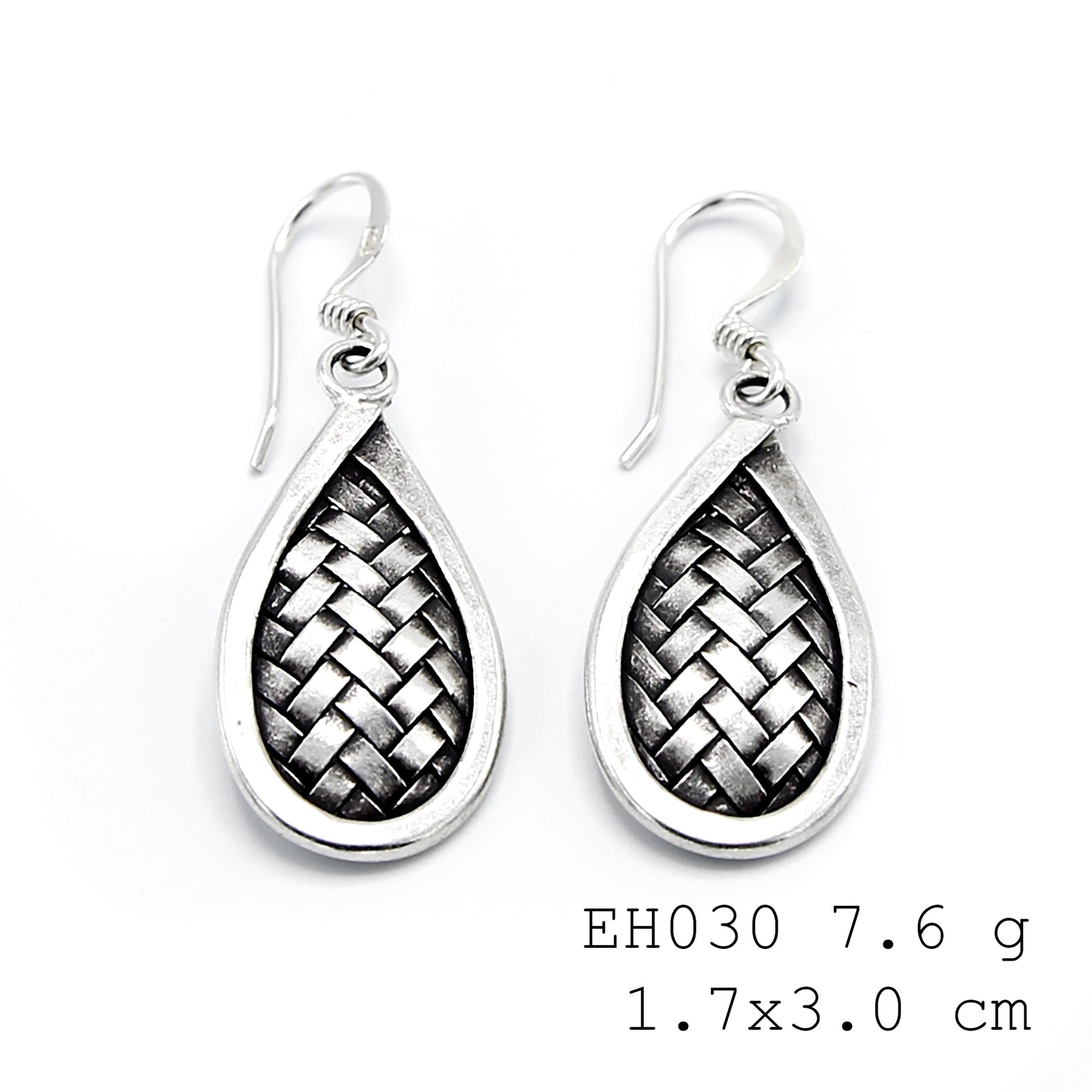 Statement weaves, subtle silver earrings.