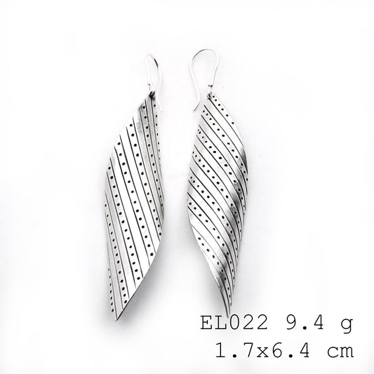 Artisan craftsmanship meets nature in these silver earrings.