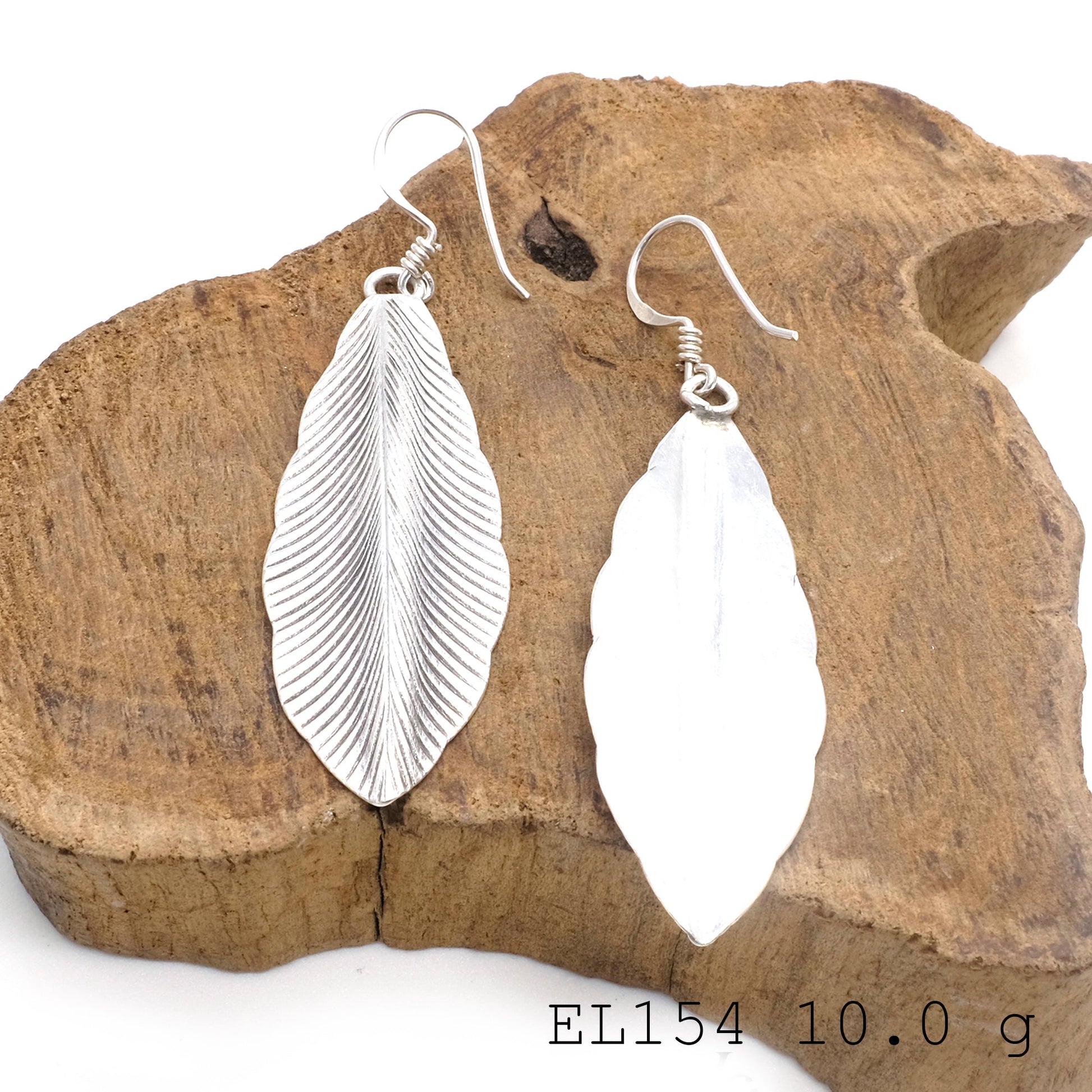 Your signature look: leaf-shape silver earrings.