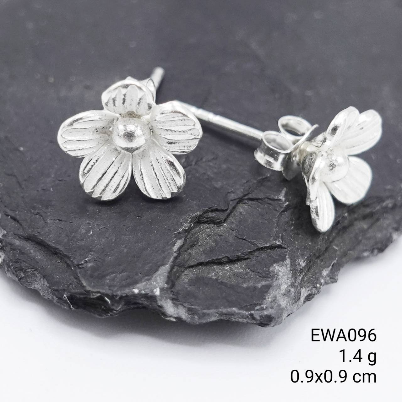 Hand-carved beauty: Our signature white flower silver earrings.