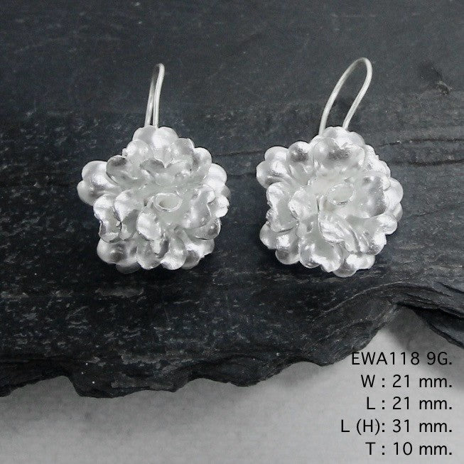 Pure elegance in every petal. Discover our white flower silver earrings.