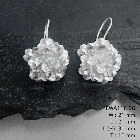 Pure elegance in every petal. Discover our white flower silver earrings.