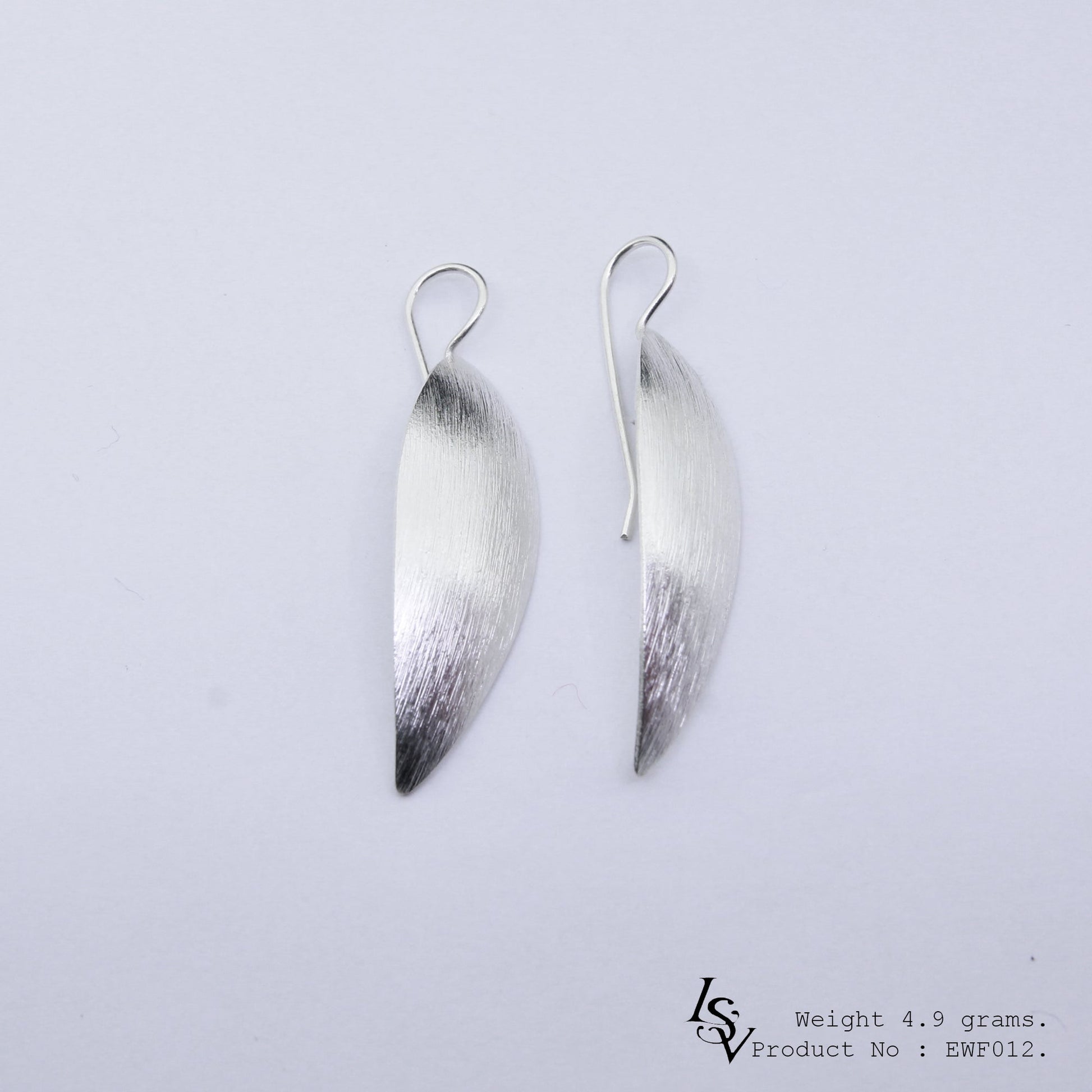 Own a piece of art: Handmade white sheet silver earrings.