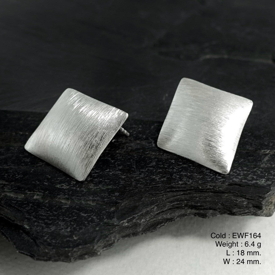 Is it a sculpture or jewelry? Shop white sheet silver earrings.