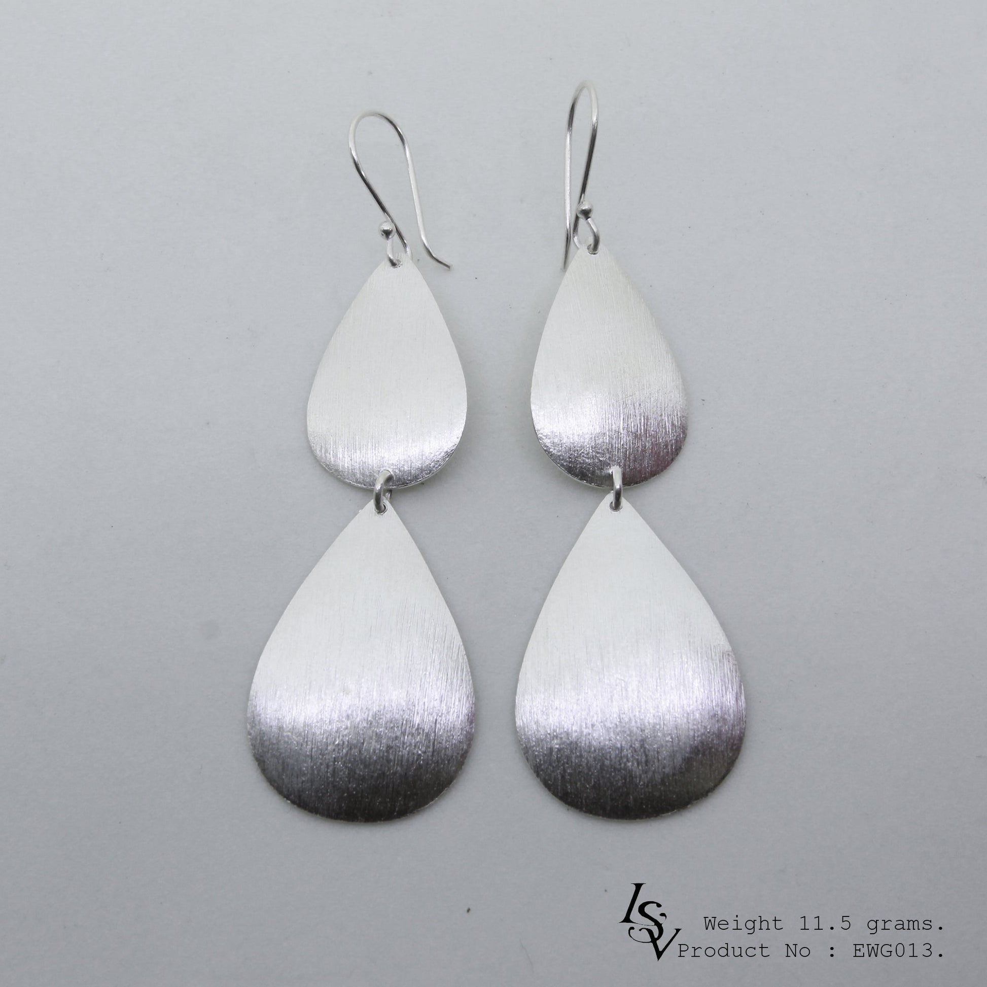 Two layers of pure elegance. Shop our handmade silver earrings.