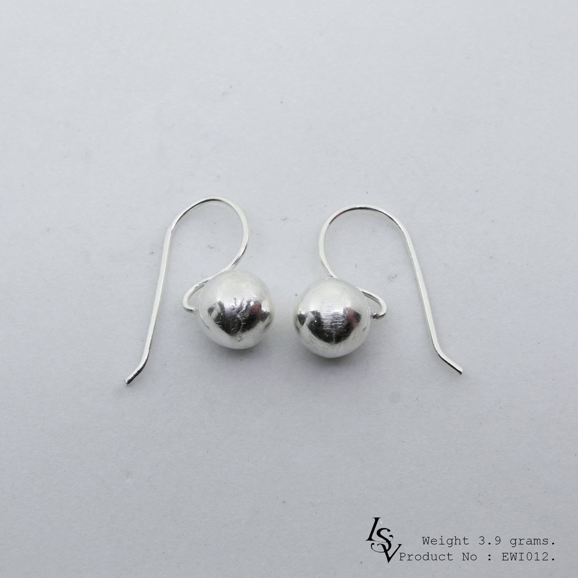Elegant and timeless white ball shape silver earrings.