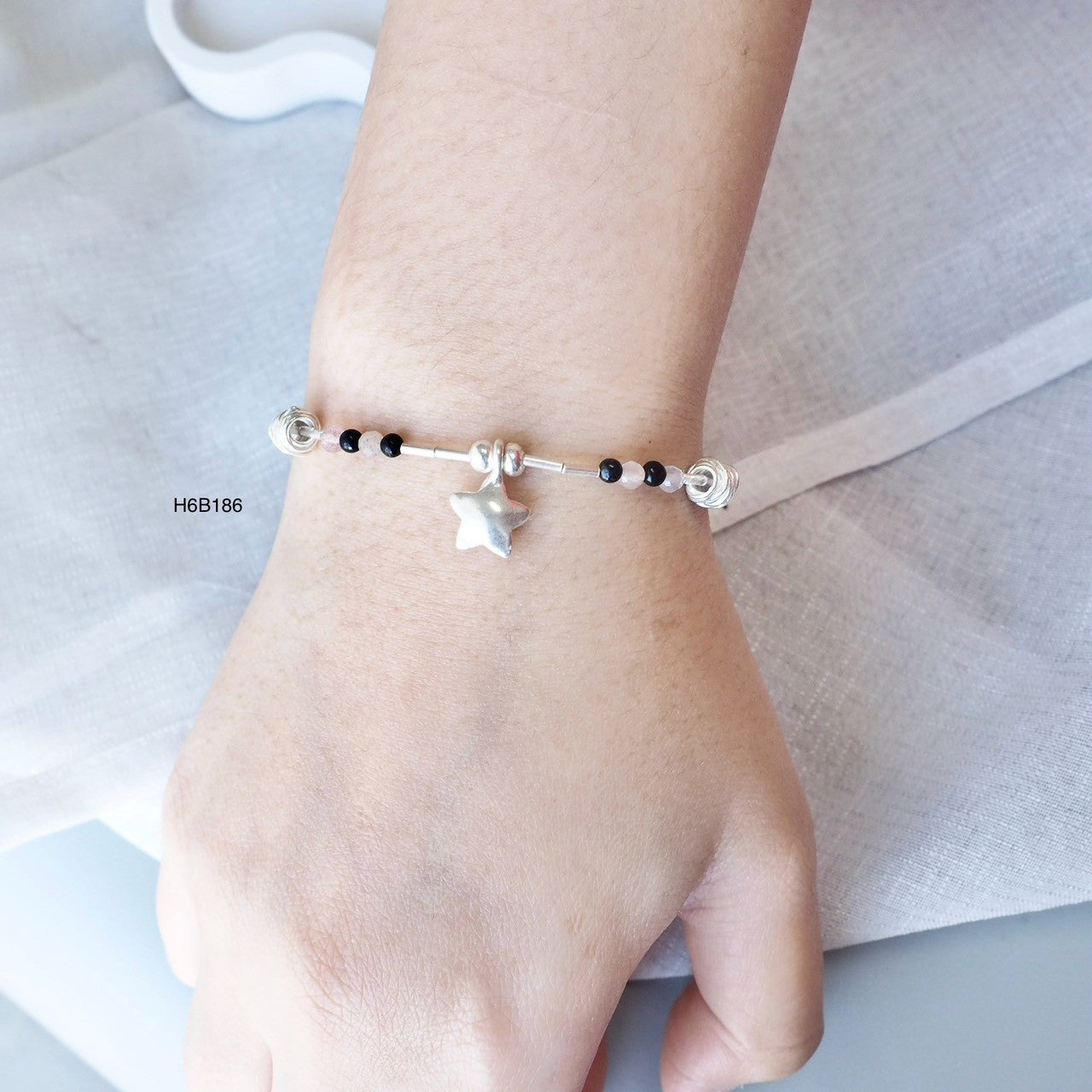 Bring a piece of Thailand home with this silver bracelet.