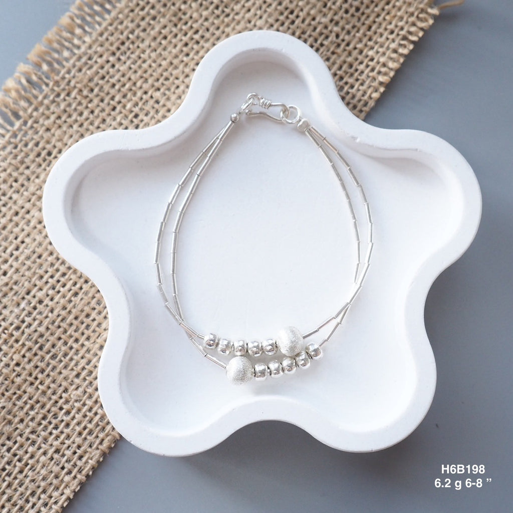 Go minimalist with a sleek, 98% pure Thai silver bracelet.