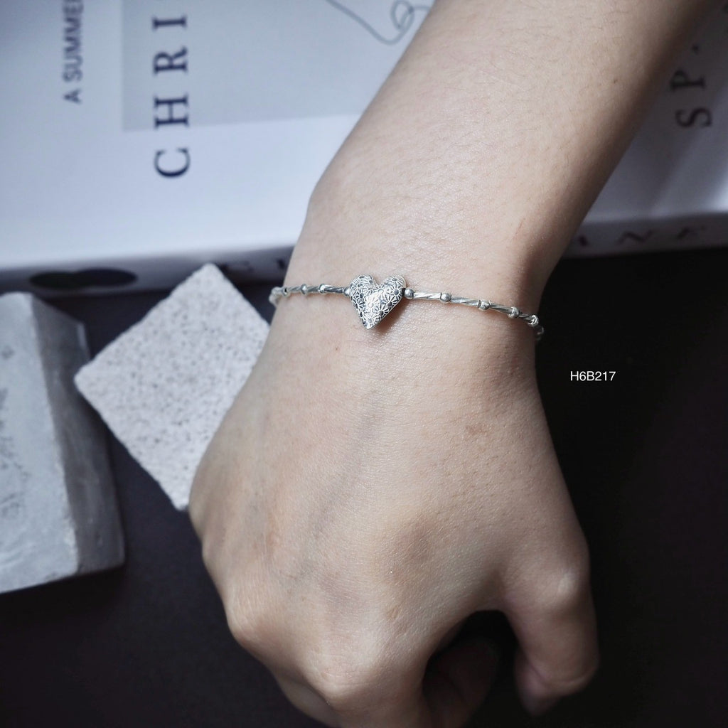Detailed by hand, inspired by Thailand. Rock this silver bracelet.