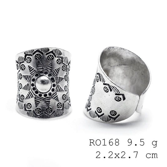 Petals and patterns on a silver ring.