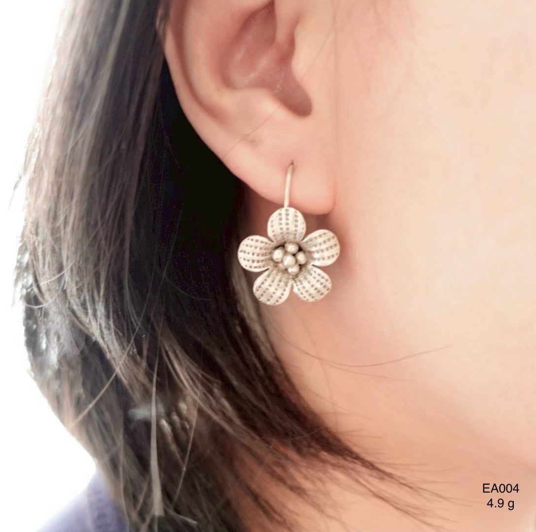 Understated elegance. Wear silver earrings.