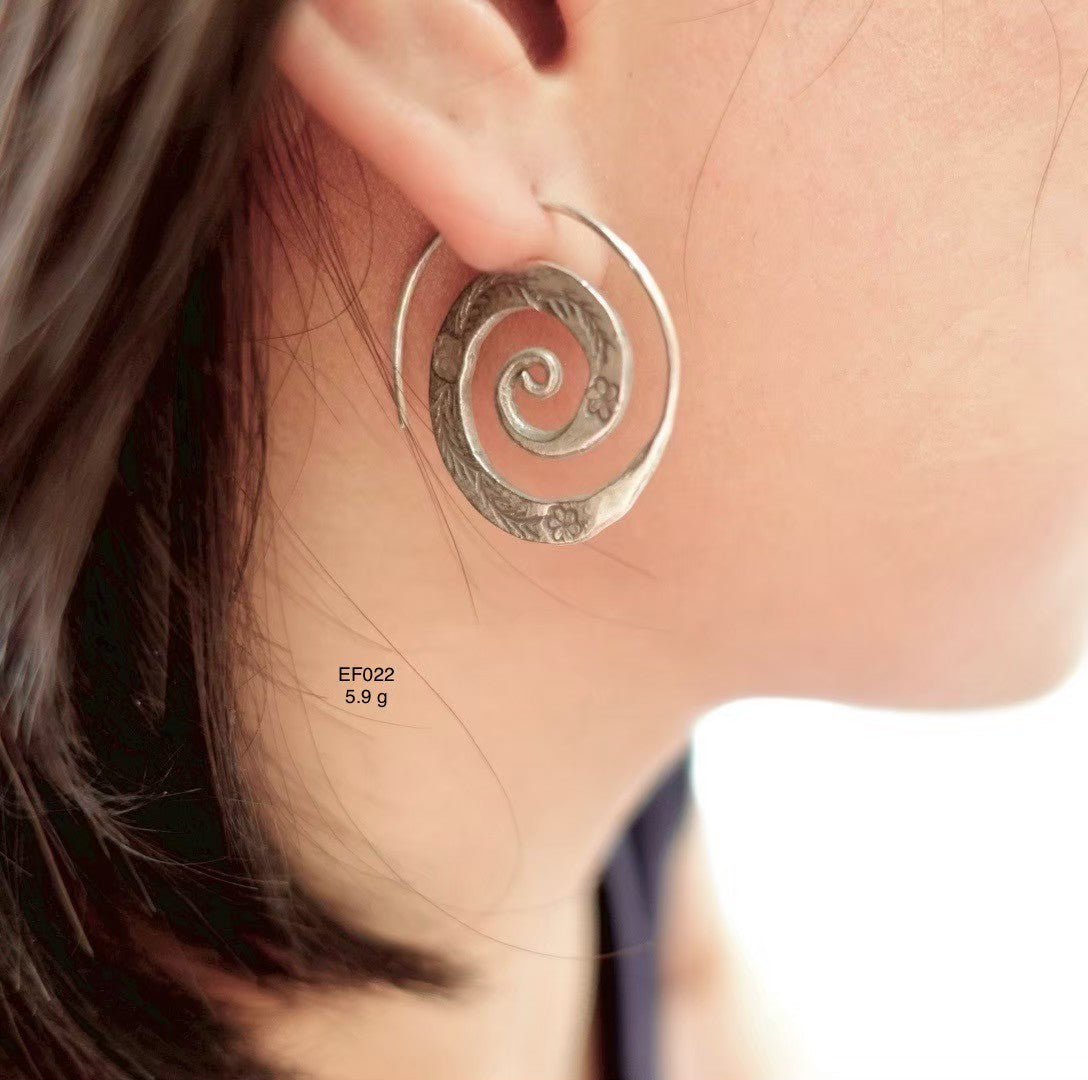 Effortlessly chic. Wear silver earrings.