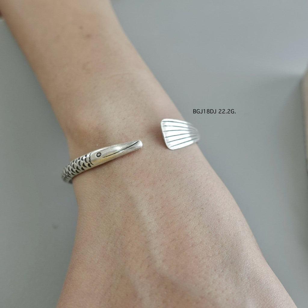 Silver bangle, artisan-crafted perfection.
