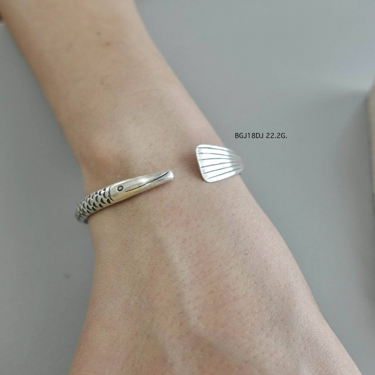 Silver bangle, artisan-crafted perfection.