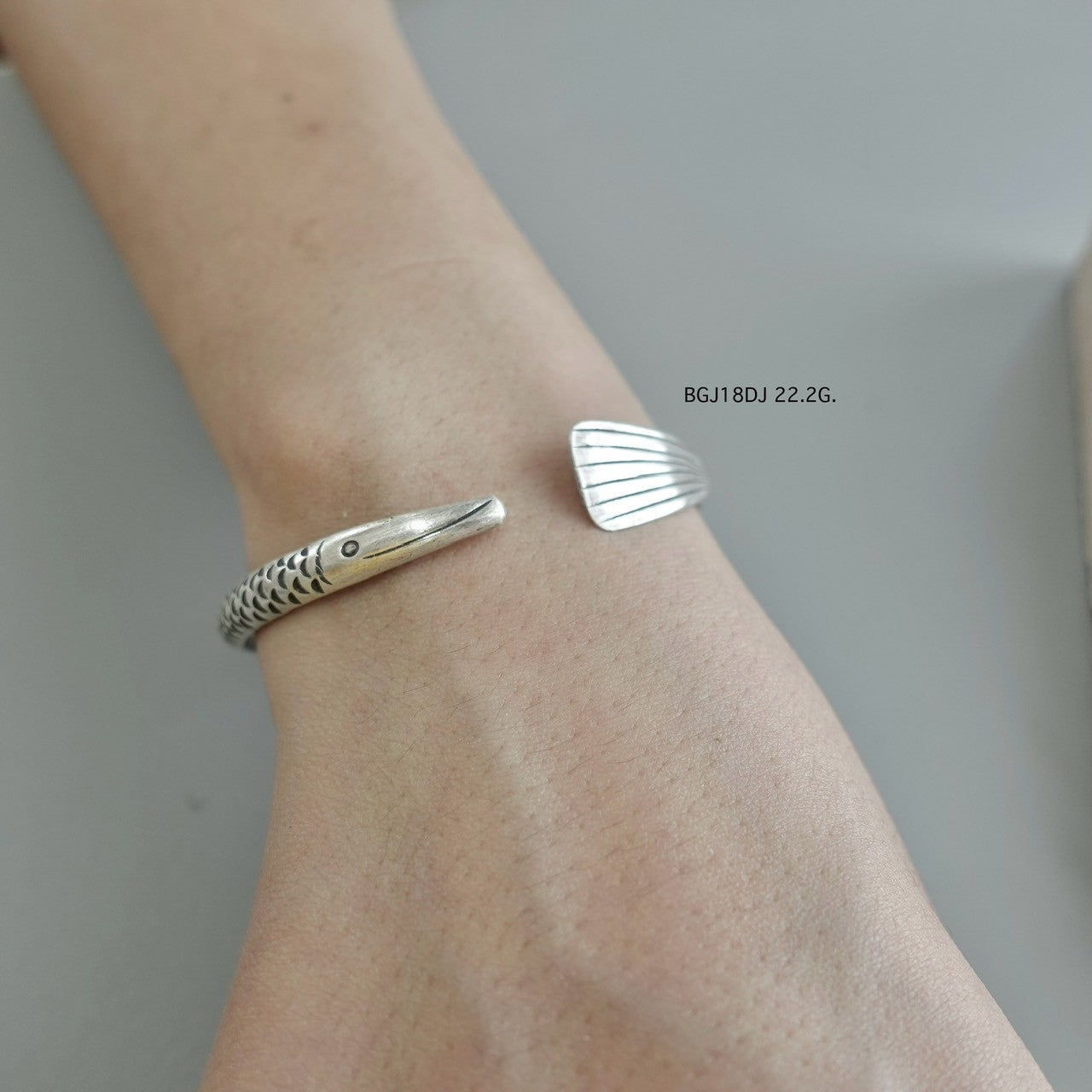 Silver bangle, artisan-crafted perfection.