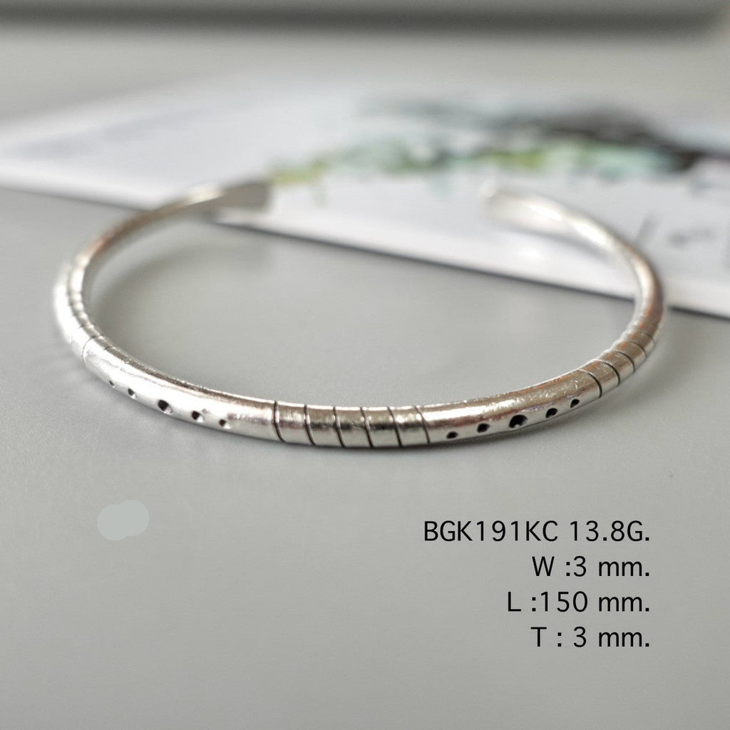 Simplicity shines in a silver bangle.