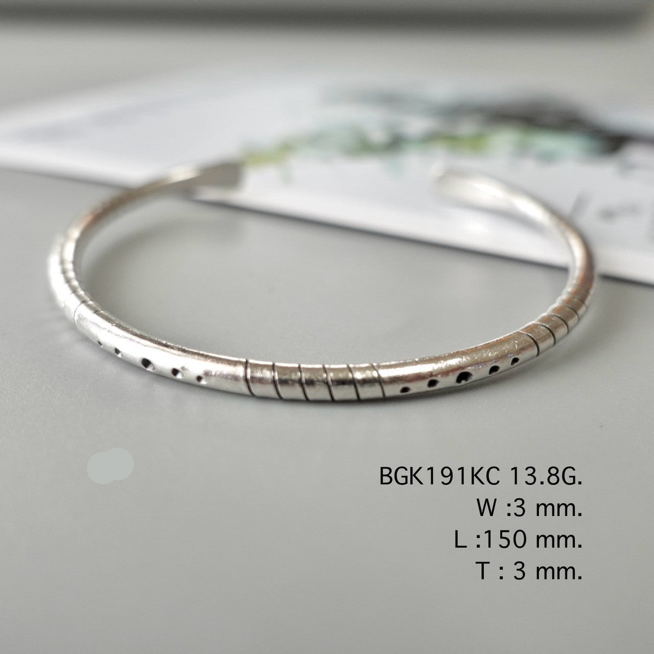 Simplicity shines in a silver bangle.