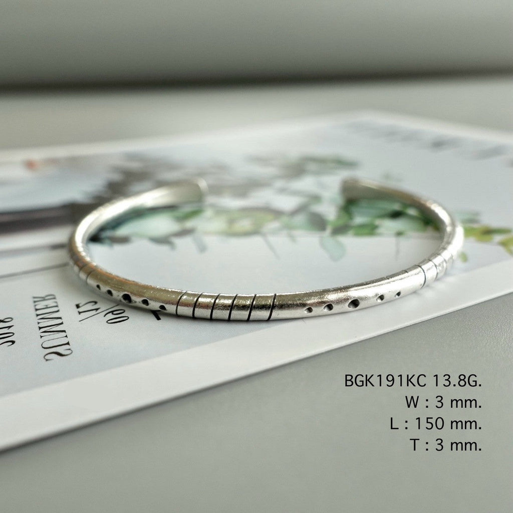 Simplicity shines in a silver bangle.