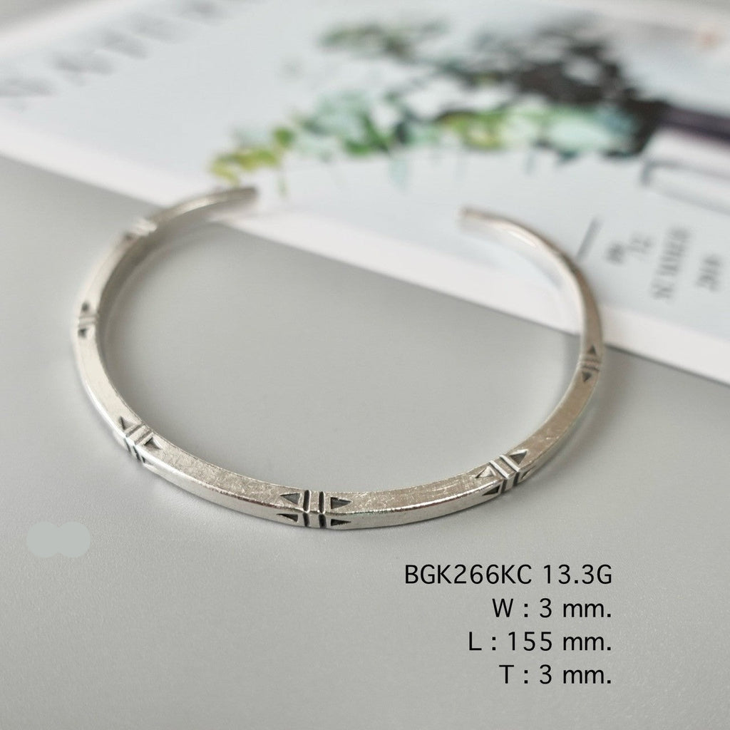 Add grace with a silver bangle.