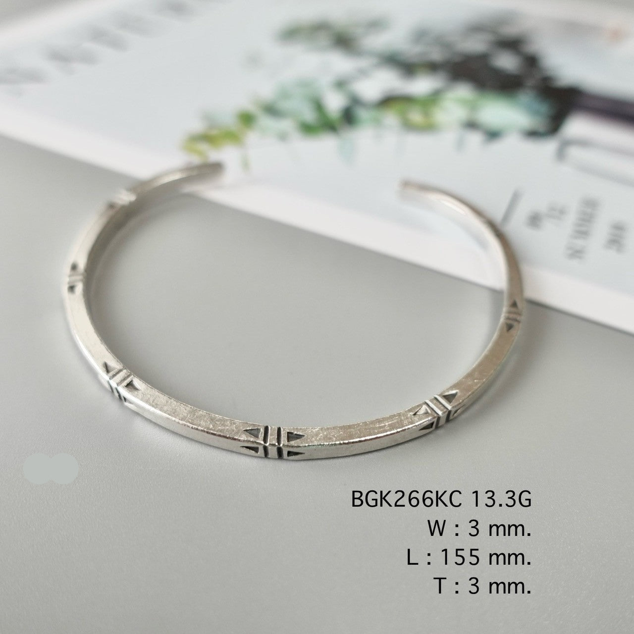 Add grace with a silver bangle.