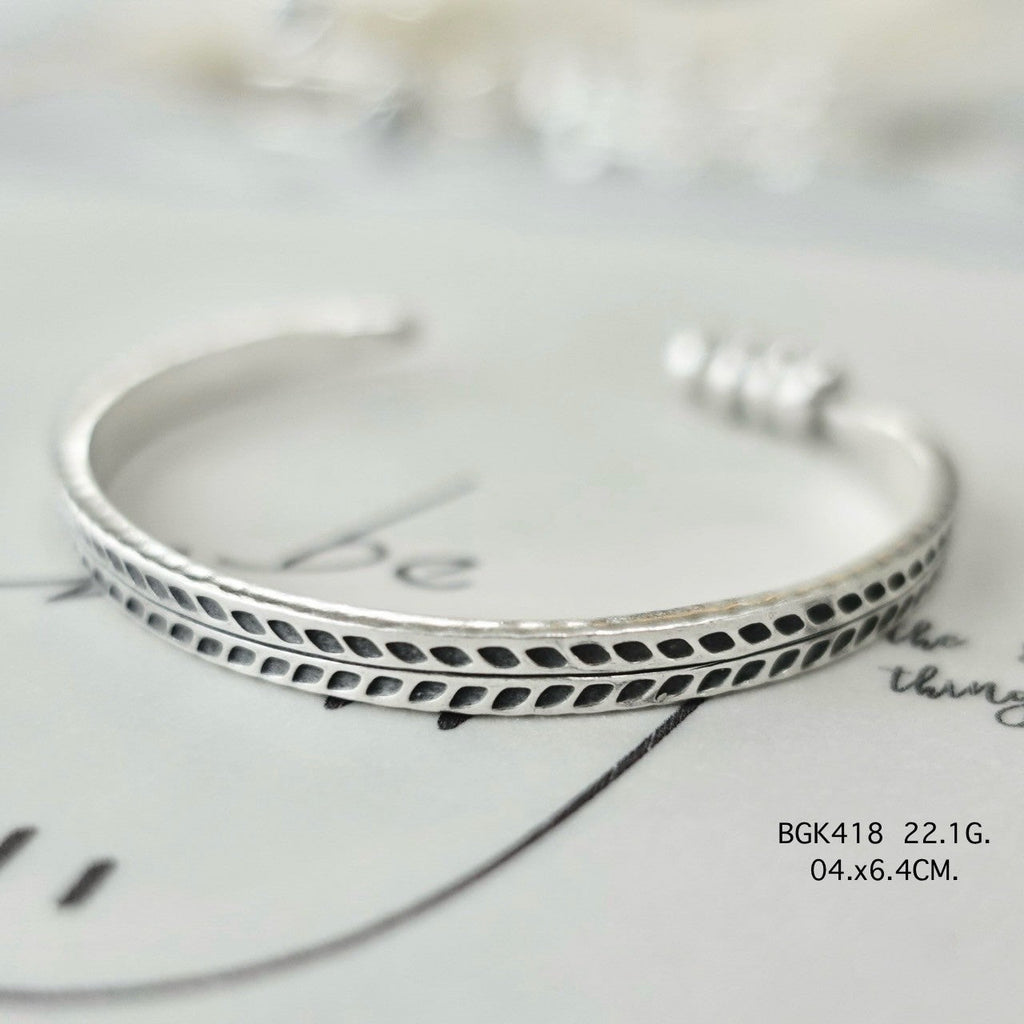Silver bangle. Luxury, rooted in tradition.